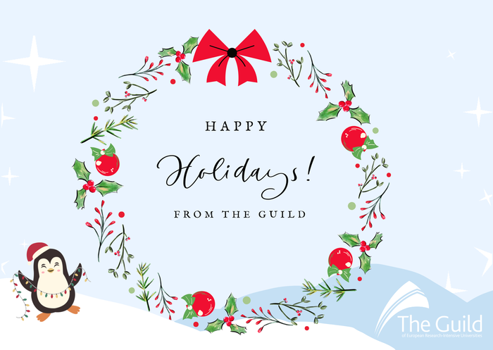 Christmas card saying Happy holidays from The Guild. A wreath and a penguin.