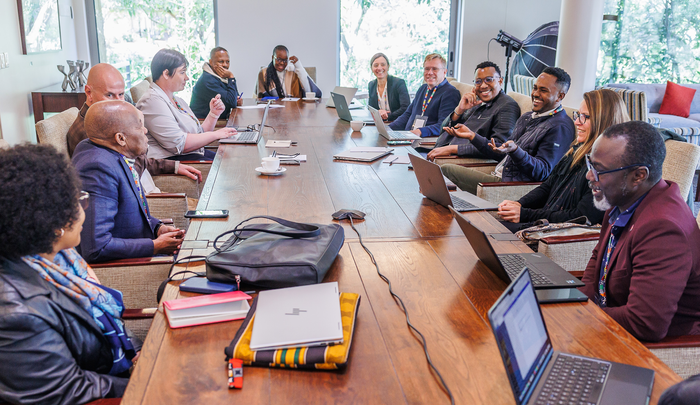Photo of people sitting around a table having a meeting at the Africa-Europe CoRE conference 